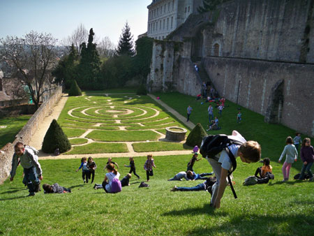 Children rolling down in Chartres Cathedral garden